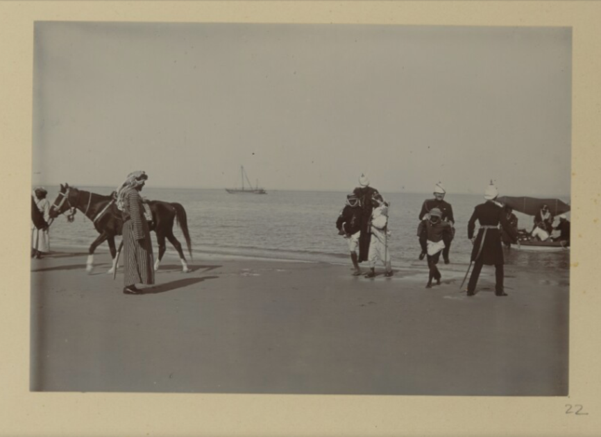 Lord Curzon and his staff are being carried ashore by Arab men