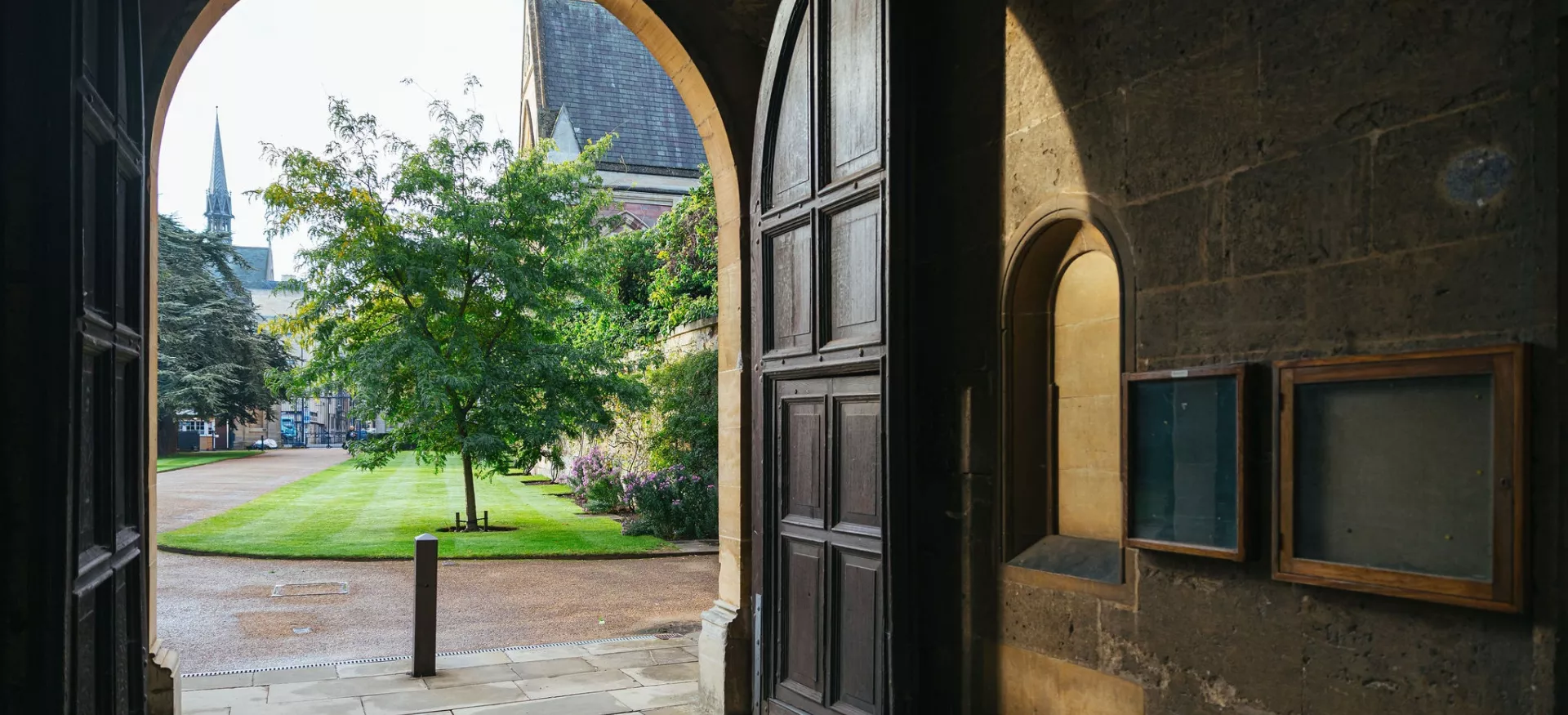 A view from under the Chapel arch of Trinity college out toward the college entrance, with Broad Street in the background.