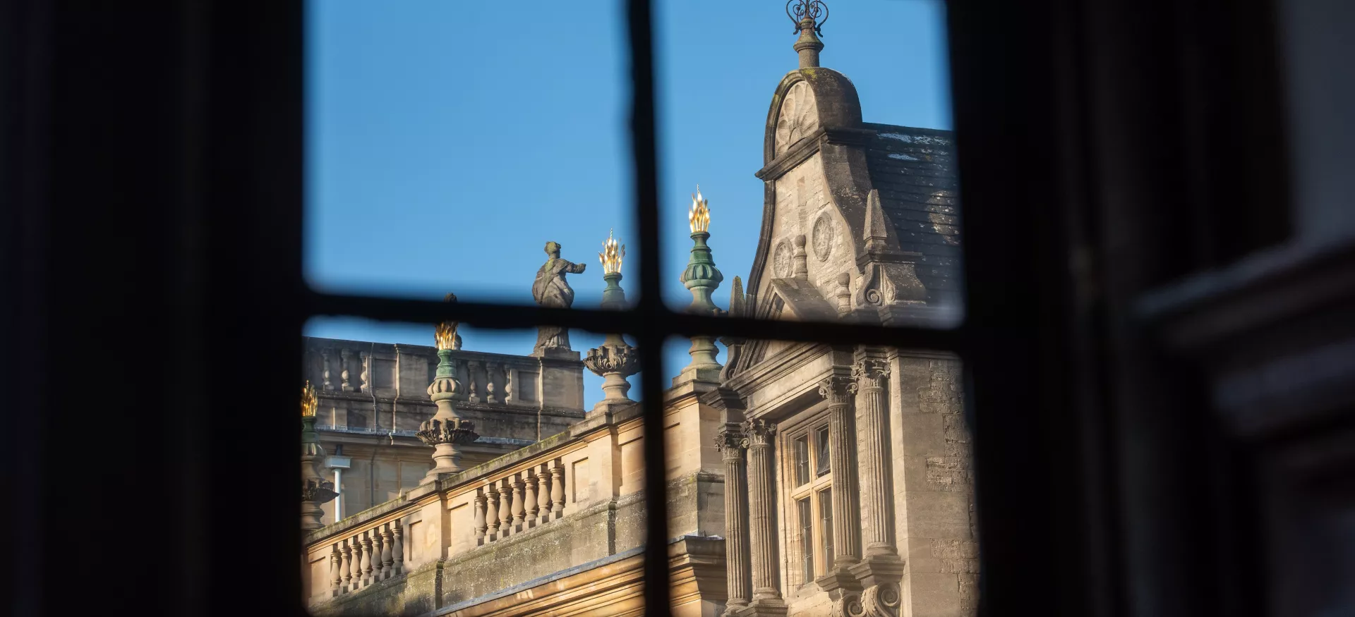 A view of the Trinity College chapel and president's lodgings through a window. 
