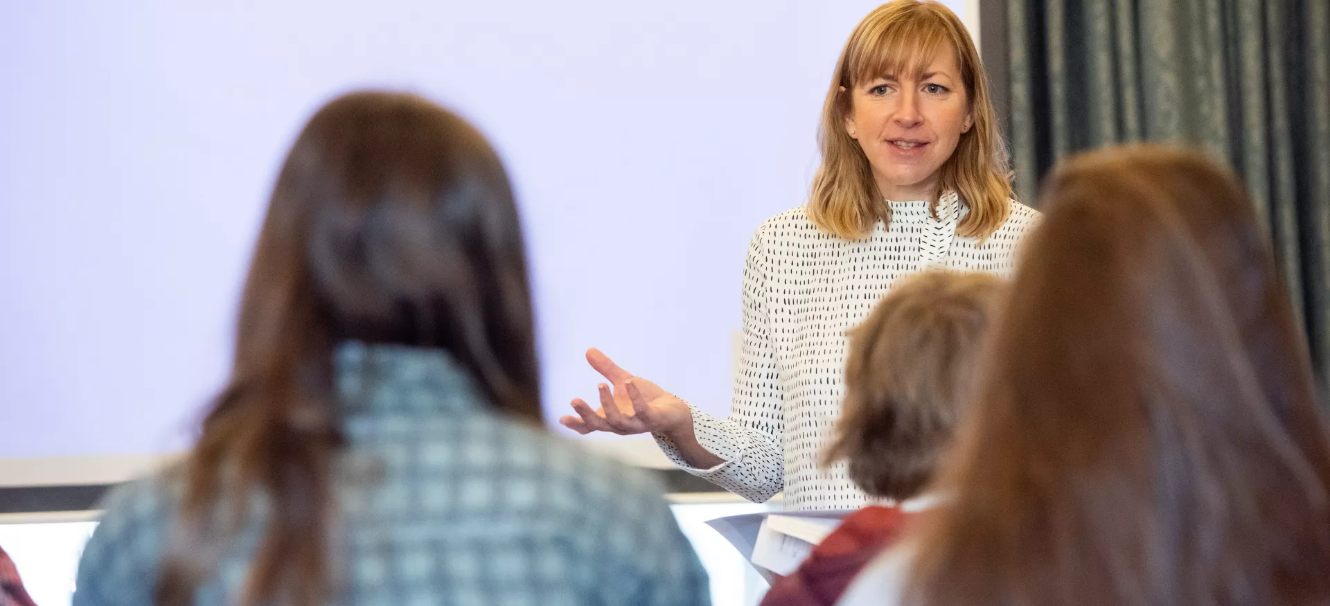 Trinity Head of Access Hannah Rolley gestures during a visit with school students.