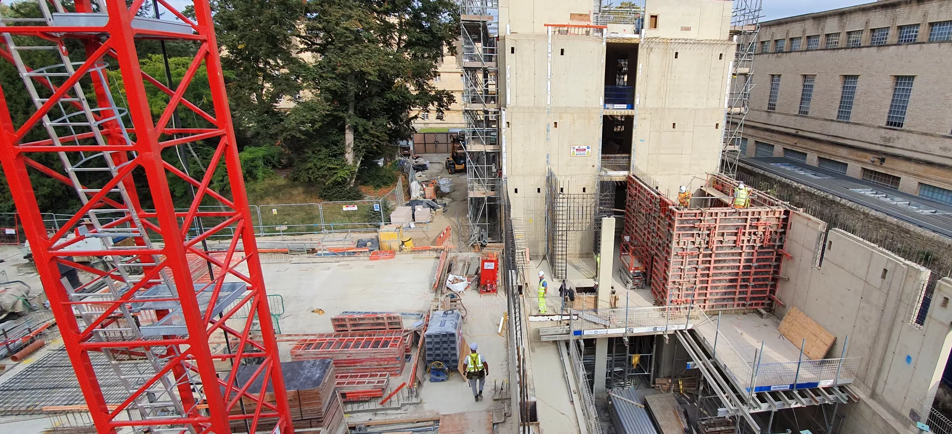 An aerial view of the project site for the Trinity College Levine Building, with lots of construction machines on the ground.