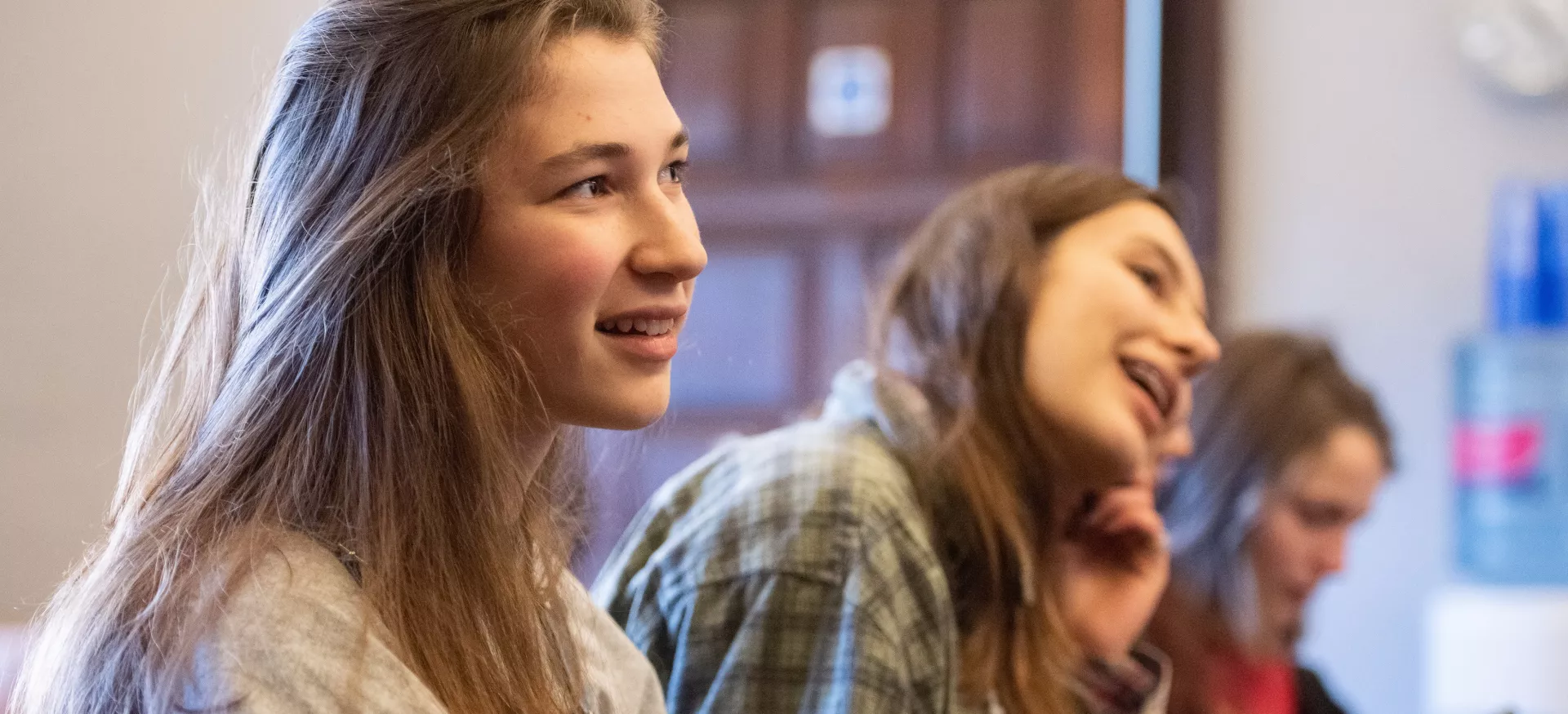A group of female students during an outreach session at Trinity college watching a presentation.