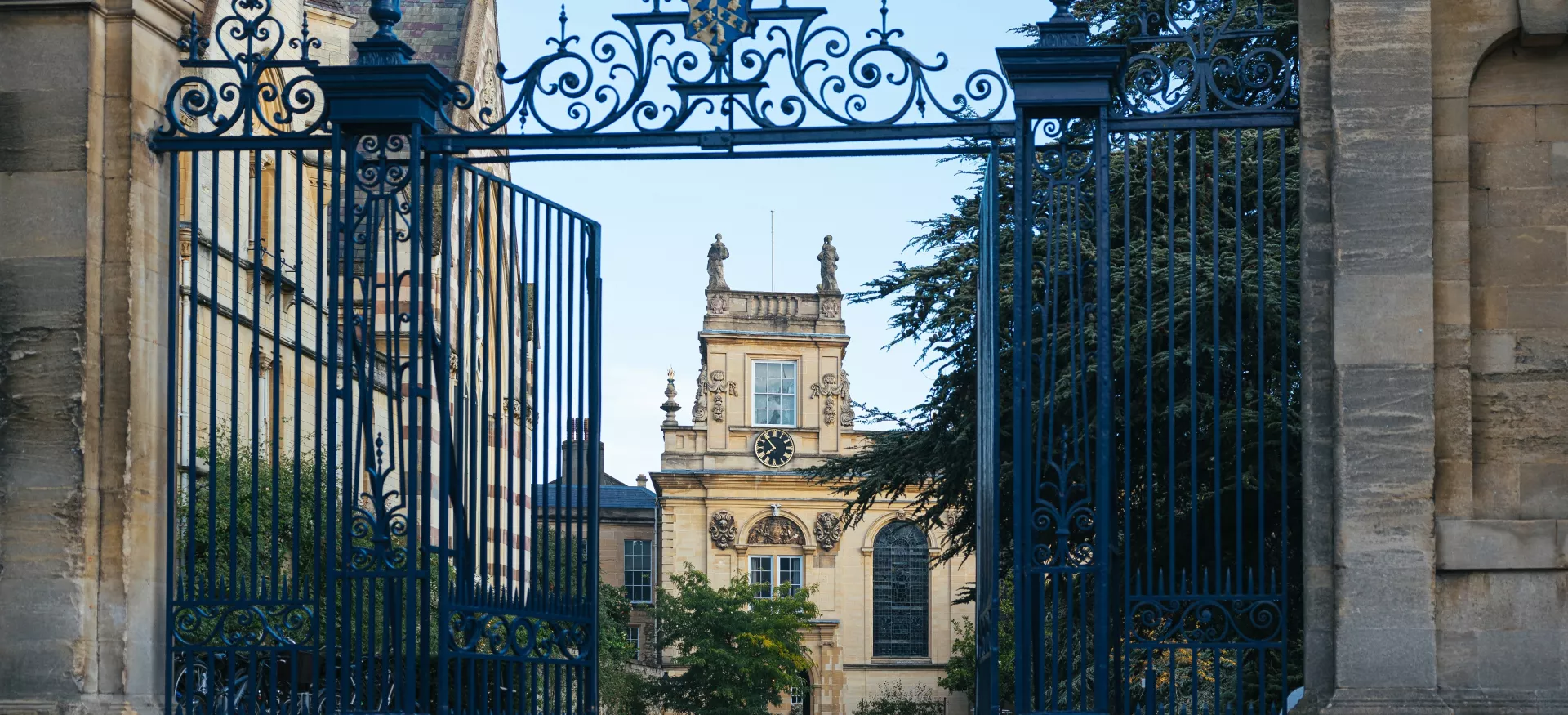 A view of Trinity College's Front Quad and chapel tower through its open front gates.