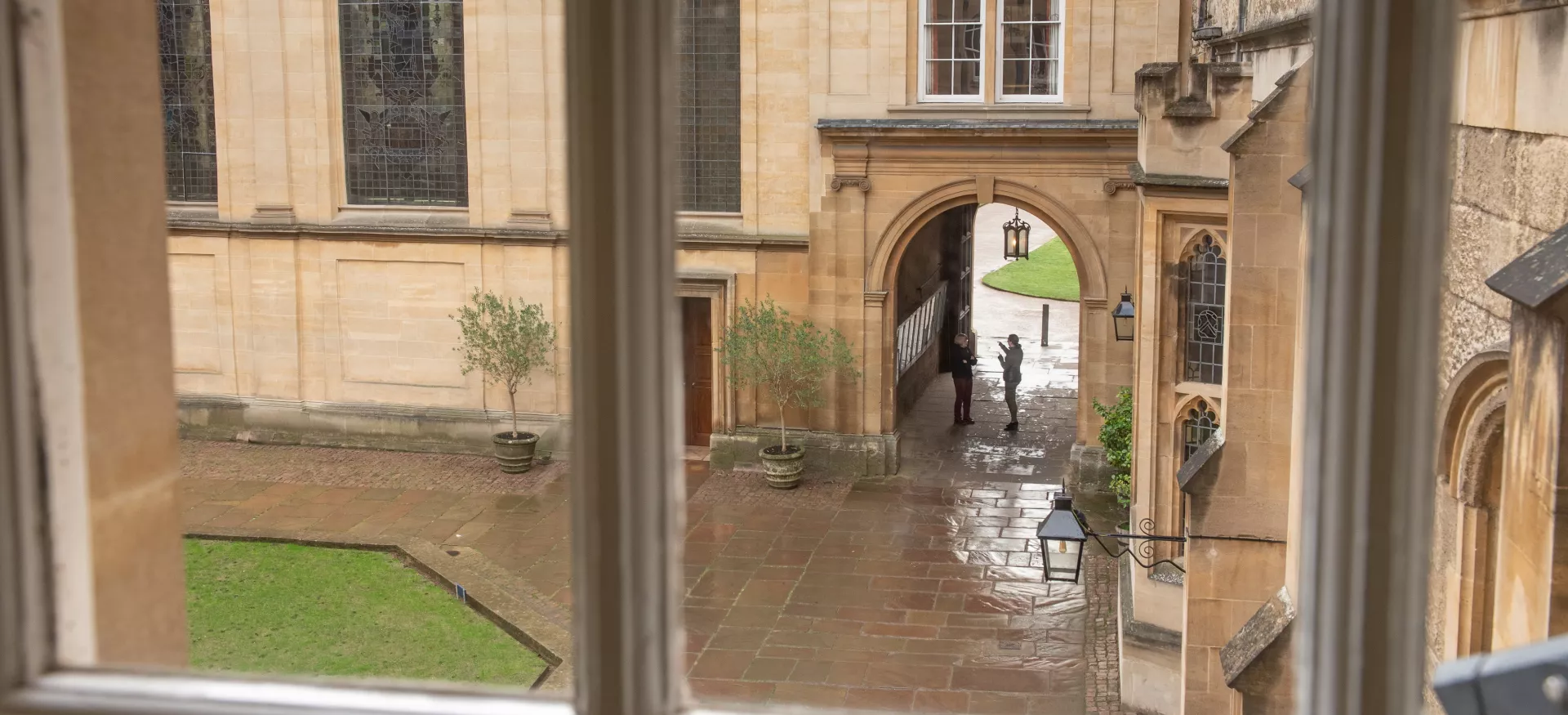 A view out of a second-floor window in Trinity College onto the quad below.