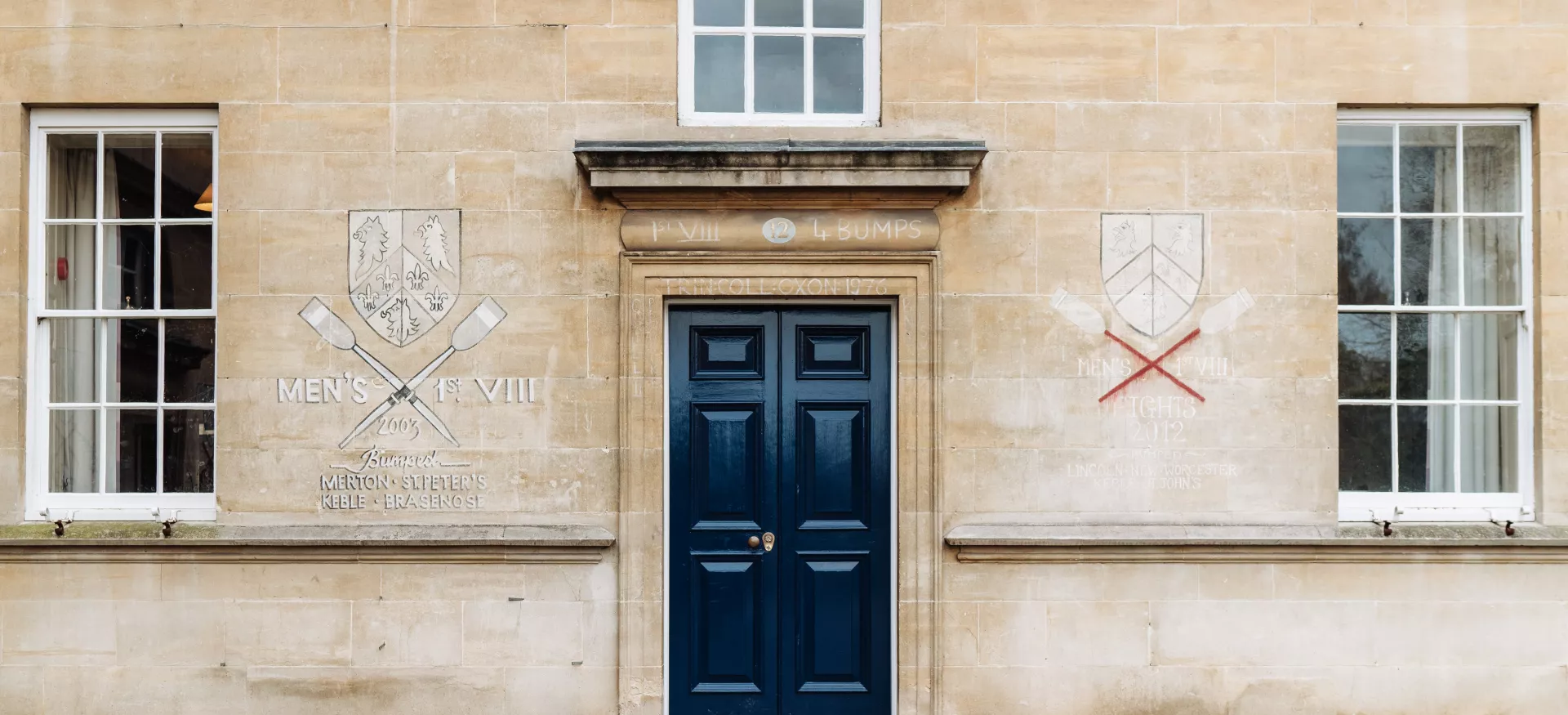 A staircase doorway in Trinty's Garden Quad with chalked drawings faintly visible.