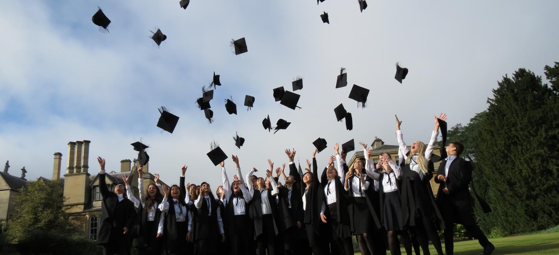 Group of students throwing mortar boards into the air
