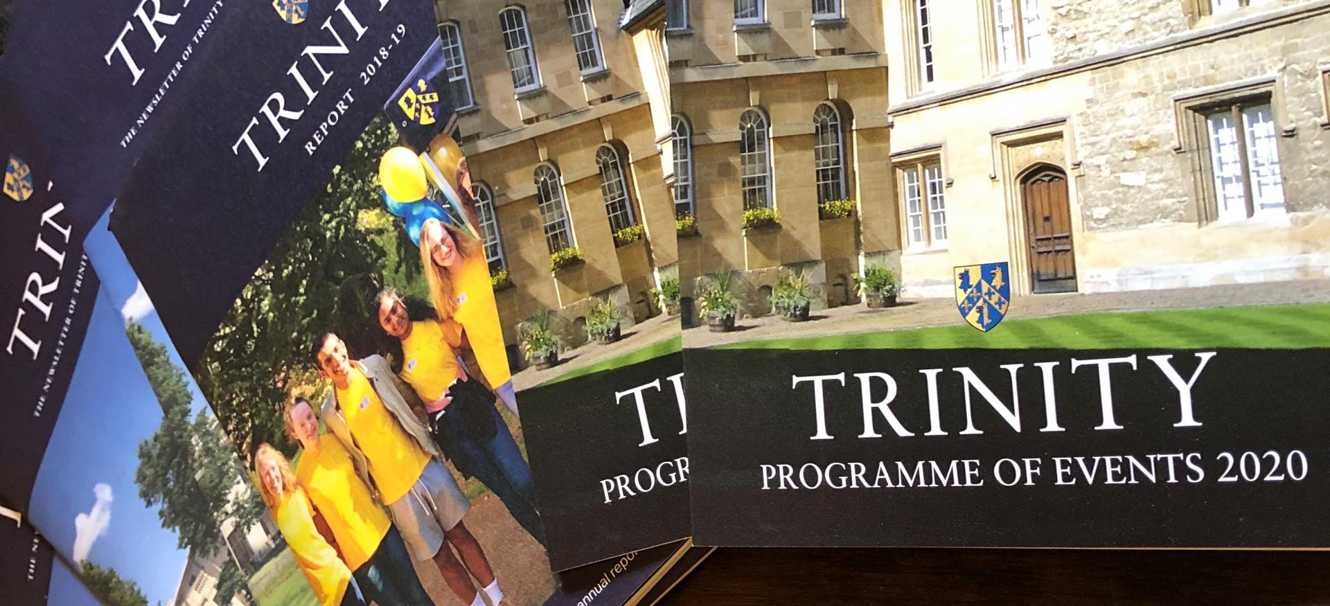 A display of Trinity College Development and Alumni publications on a table.