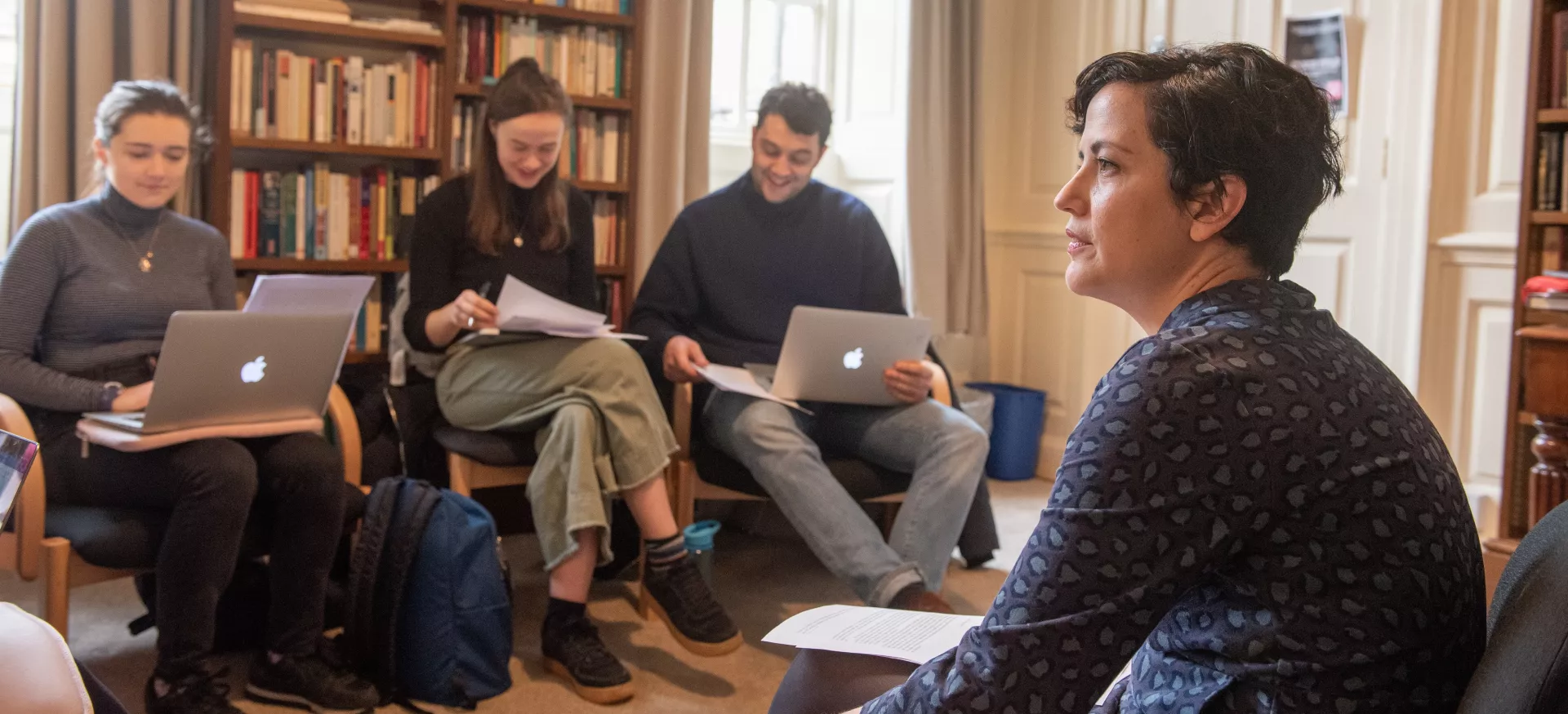 Trinity tutor Maria Blanco sits listening to students during a tutorial.