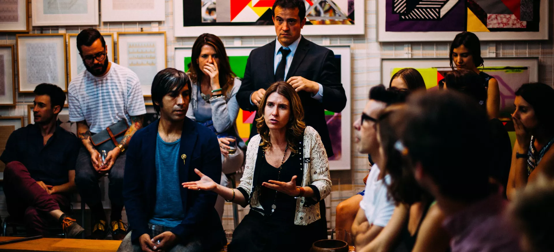 A group of teachers gather together in a classroom discussion group. 
