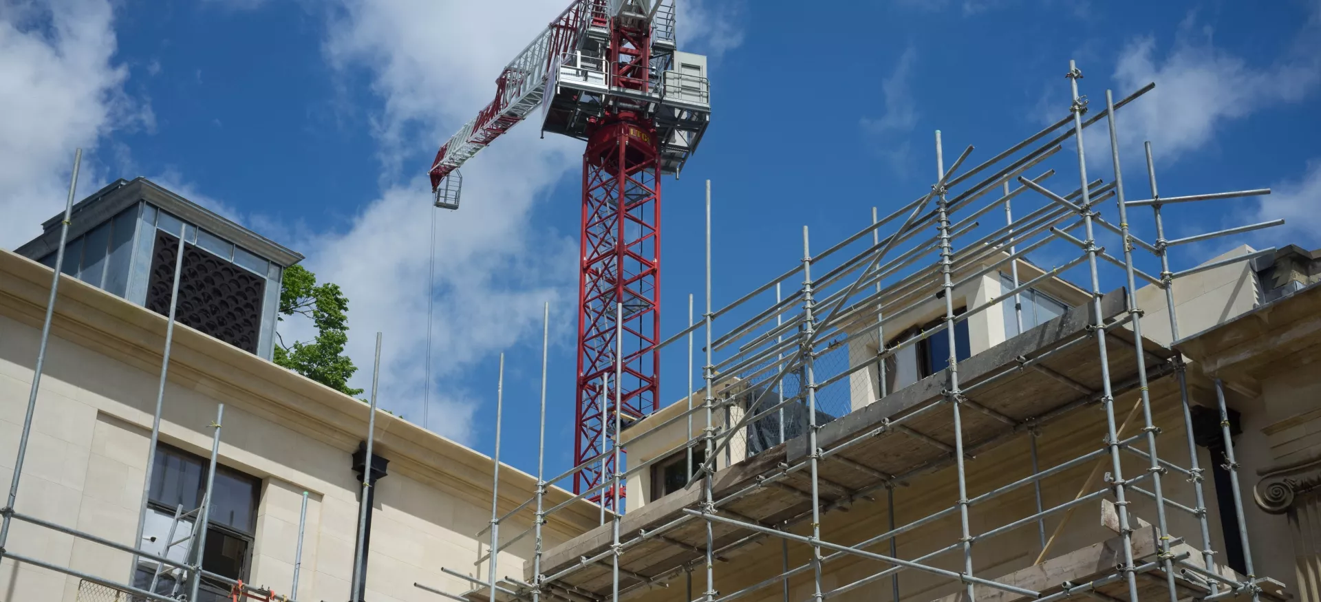 A view up at the Levine Building with crane high above.