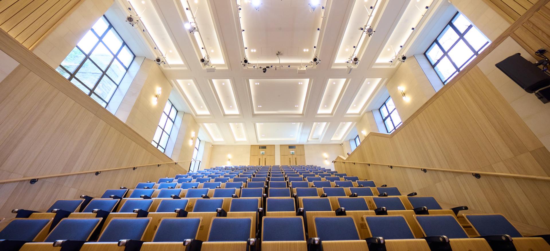 A view of the Trinity College de Jager auditorium looking upwards into the seating from the stage.