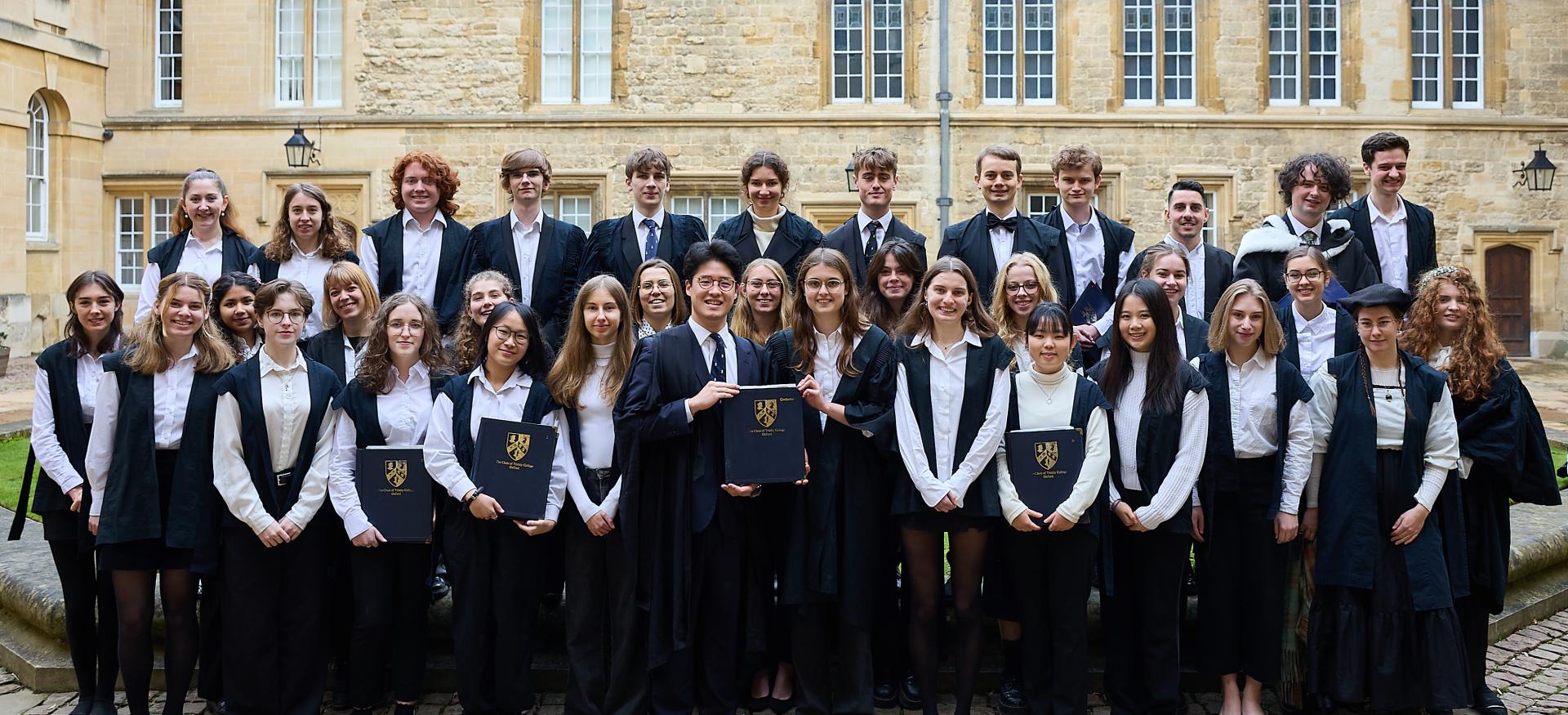 The Trinity chapel choir stand in sub fusc in the college's Durham quad.