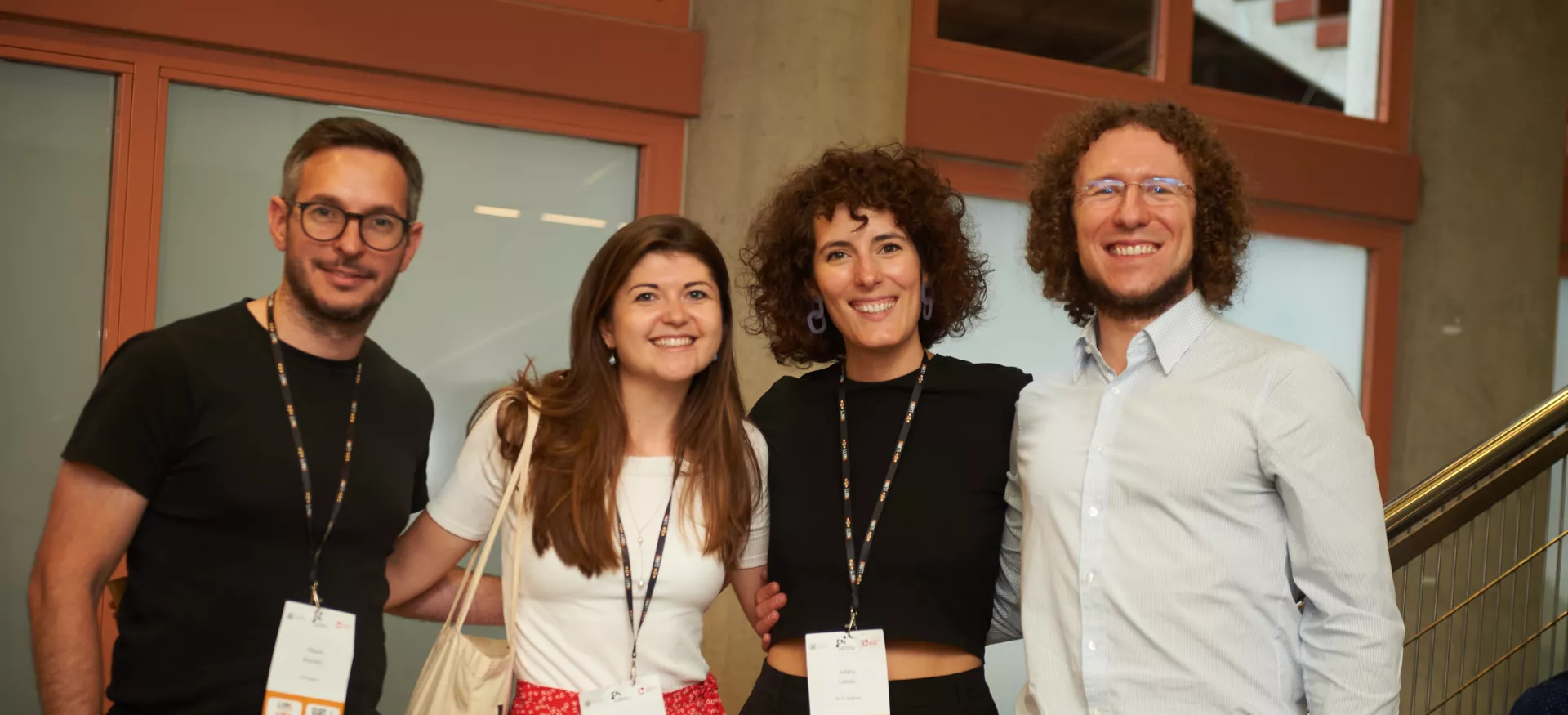 Trinity postgraduate Jo Helme stands at a conference with several colleagues.