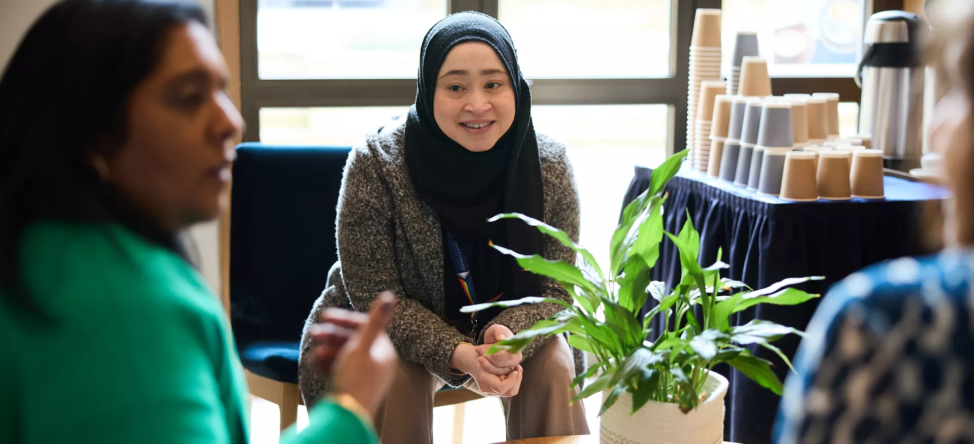 A group of teachers sit in discussion in the Trinity cafe.