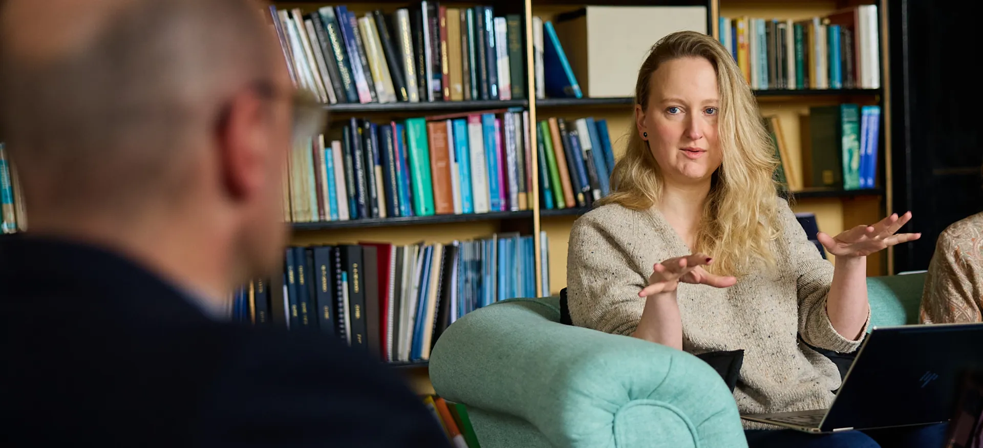 Postgraduates sit in an academic study during a seminar discussion at Trinity.