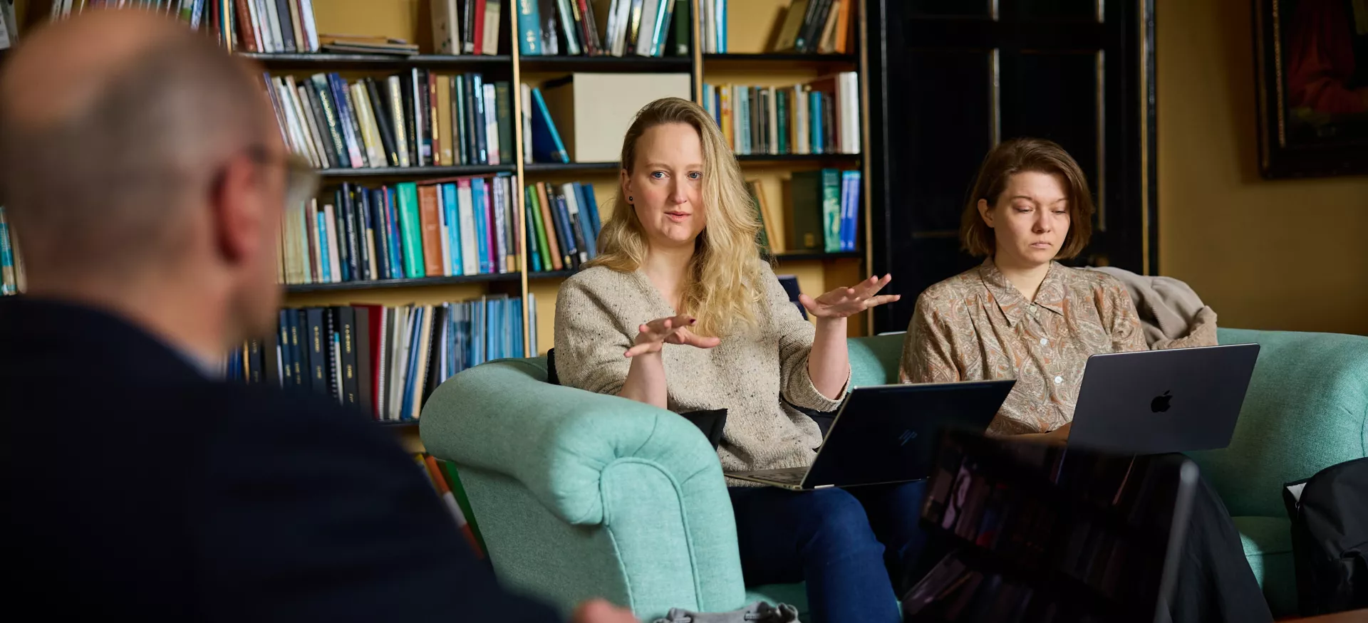 Postgraduates sit in an academic study during a seminar discussion at Trinity.