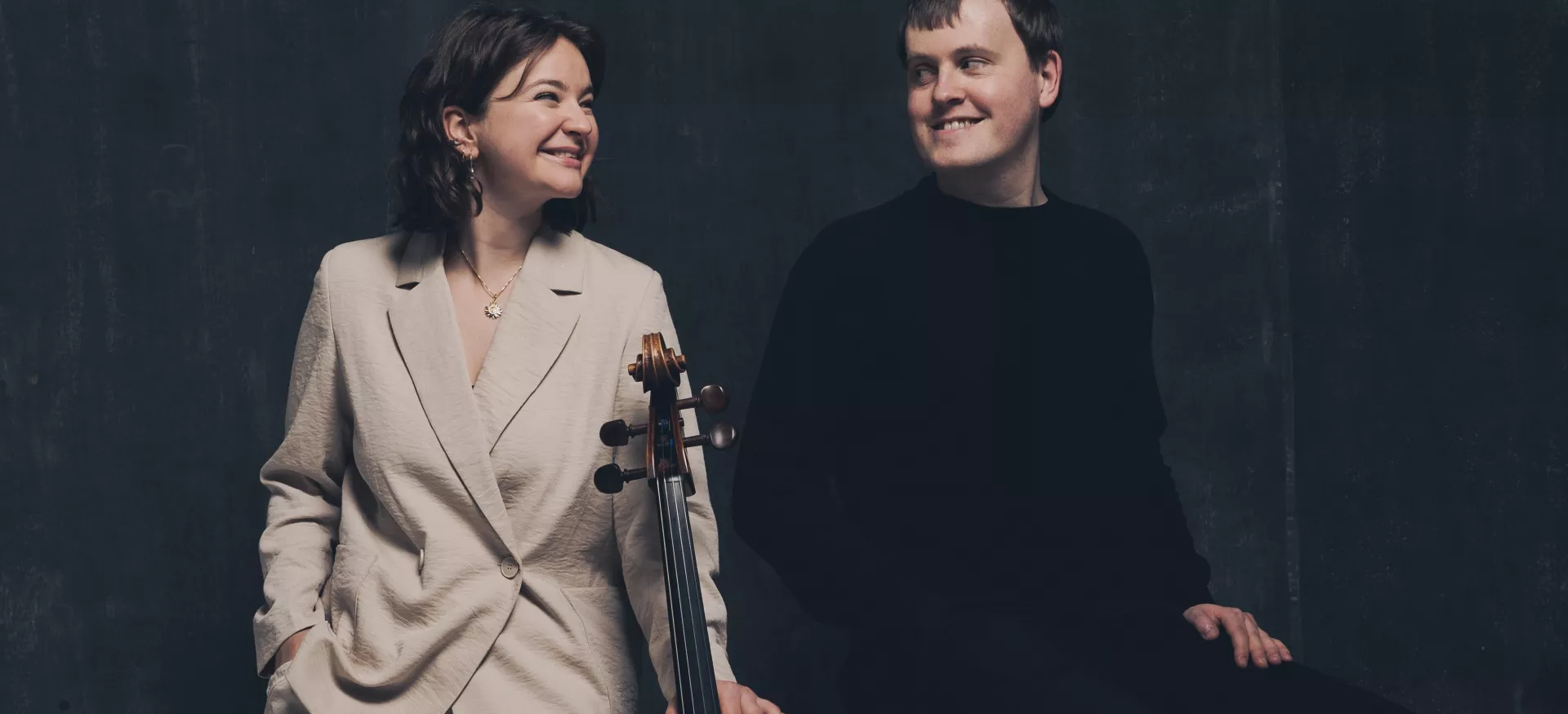 Laura van der Heijden stands with her cello next to Jâms Coleman 