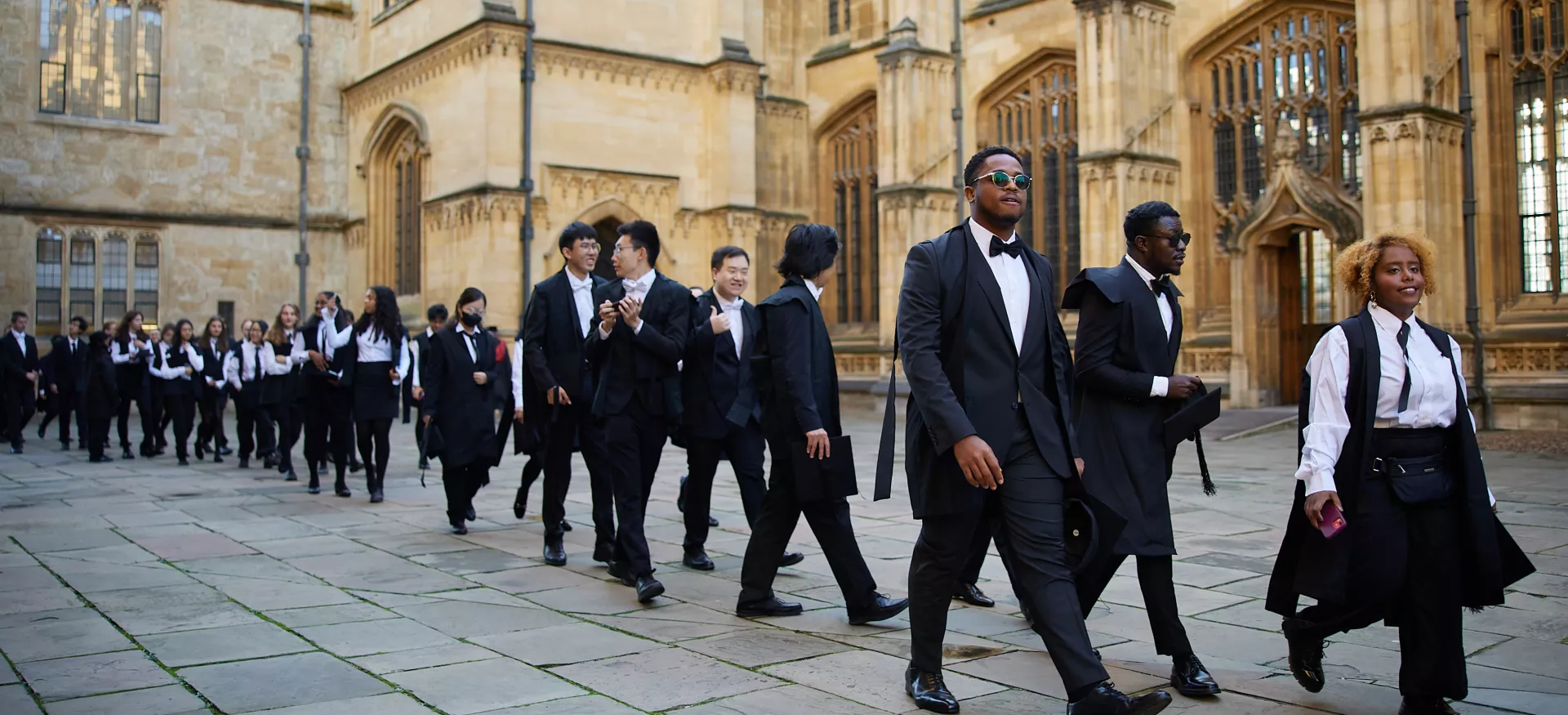 Trinity College MCR members walk in a line during matriculation. 