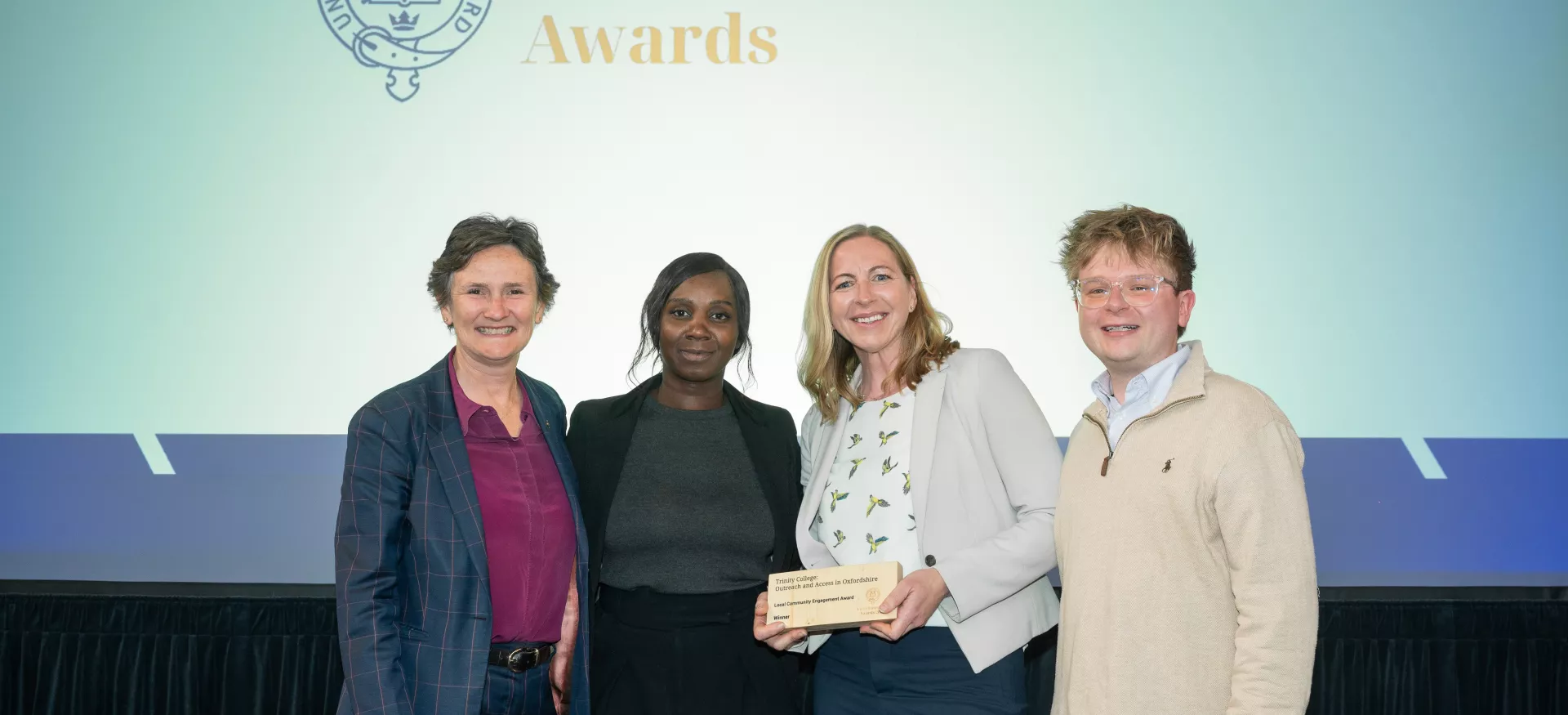 Trinity Access team members Hannah Rolley, Innocen Otunnu and Rob Harrison stand with Oxford's Vice-Chancellor, Irene Tracey.