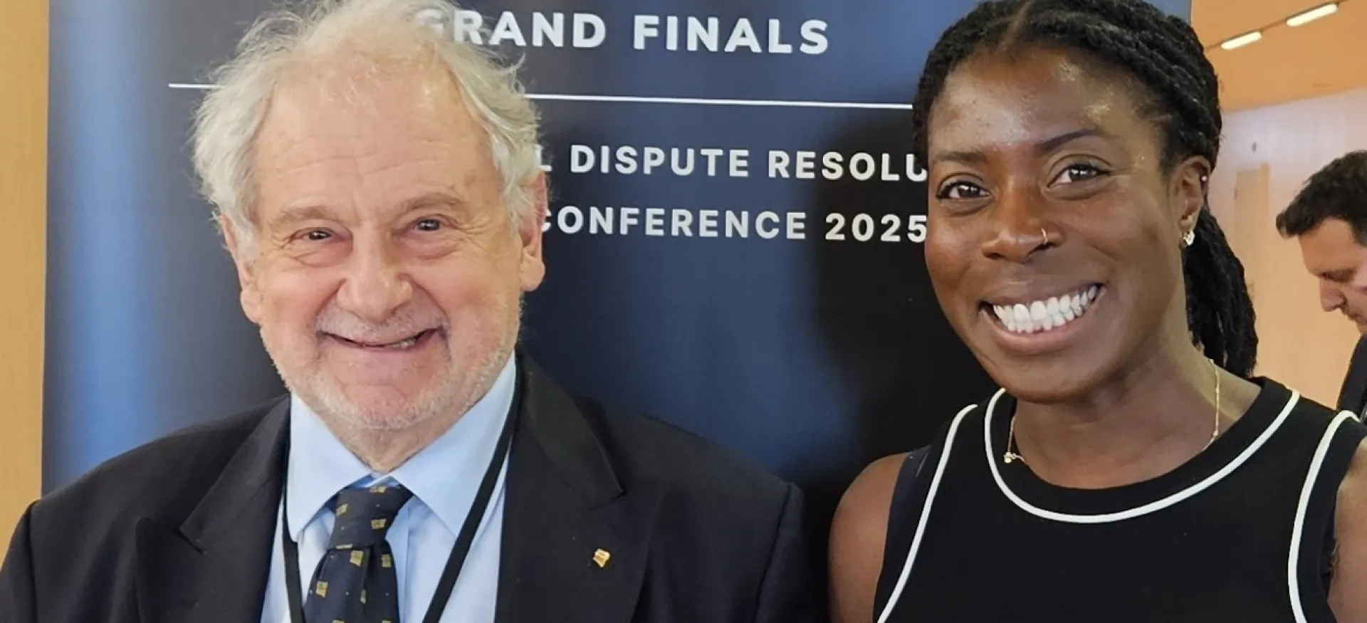 Michael Beloff stands next to British athlete Christine Ohorugu