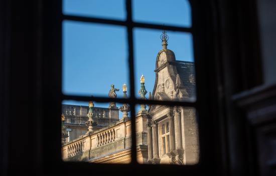 A view of the Trinity College chapel and president's lodgings through a window. 