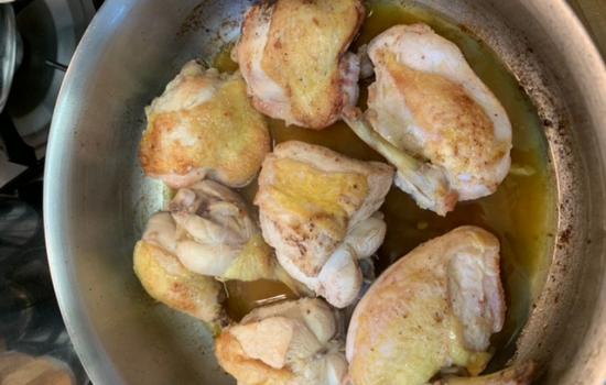 Sauteed chicken in a pan.