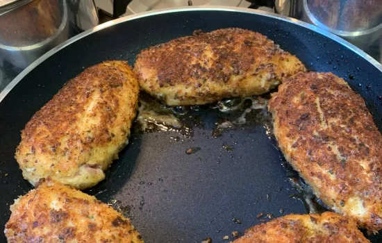 Cooked chicken cordon bleu in a frying pan.