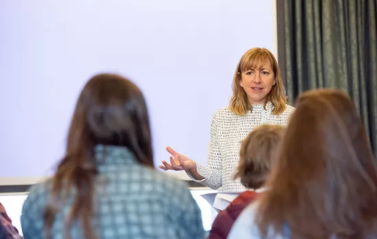 Trinity Head of Access Hannah Rolley gestures during a visit with school students.