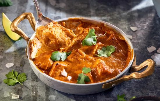 A Madras curry in a metal bowl.