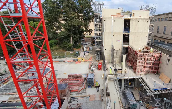 An aerial view of the project site for the Trinity College Levine Building, with lots of construction machines on the ground.