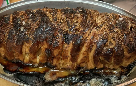 A cooked sausage meat puff pastry slice.