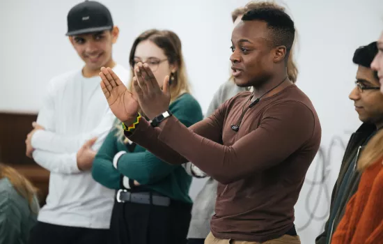 A group or Trinity student ambassadors presenting during a school visit.