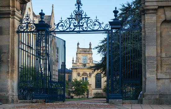 A view of Trinity College's Front Quad and chapel tower through its open front gates.