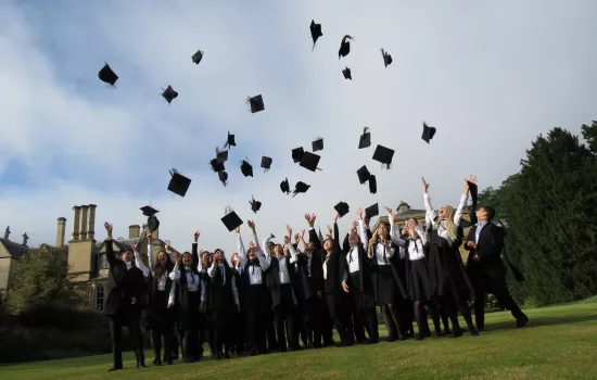 Group of students throwing mortar boards into the air