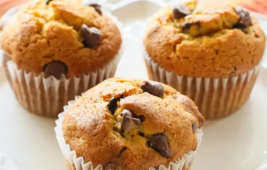 A plate of three pumpkin chocolate chip muffins.