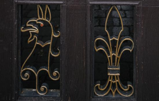 A detail from the back gate to Trinity College, with a gryphon in metal. 