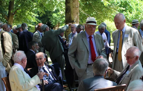 gentlemen enjoy drinks in the shade of the wilderness