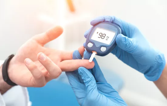 Doctor checking blood sugar level with glucometer