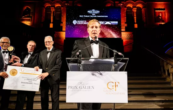 Professor Chris Butler stands giving a speech after receiving the Prix Galien Award.