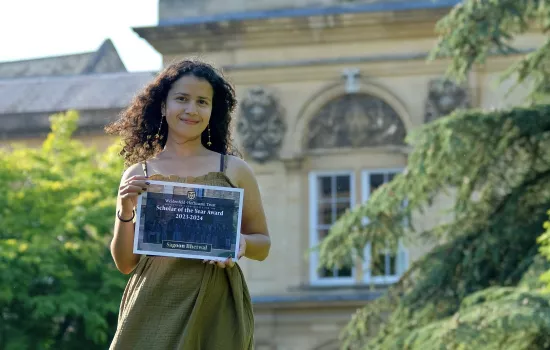 Sagoon Bhetwal stands with her Scholar of the Year award certificate outside Trinity's chapel.