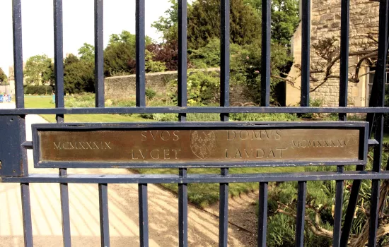 A view onto Trinity's gardens from its War Memorial Gate.