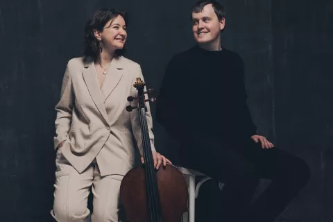 Laura van der Heijden stands with her cello next to Jâms Coleman 