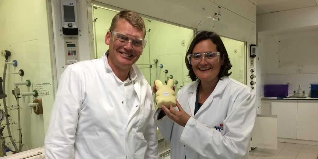 Trinity Chemistry Tutor Charlotte Williams and a male student in a lab holding a plastic bunny.