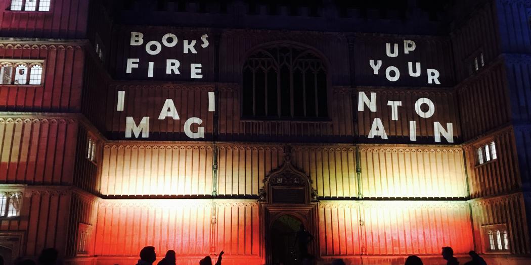 The front of the Bodleian Library, lit up with light projections reading "books fire up your imagination."