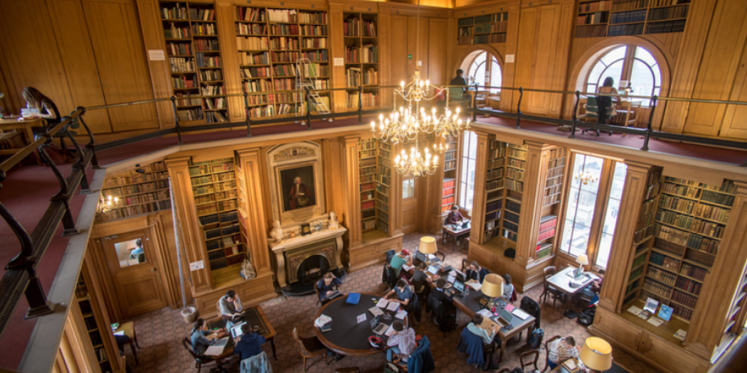 Students study at desks in an interior view of the Taylorian Languages Library.