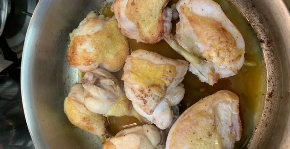 Sauteed chicken in a pan.