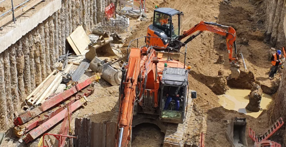 An excavator works in the basement of the Levine Building site. 