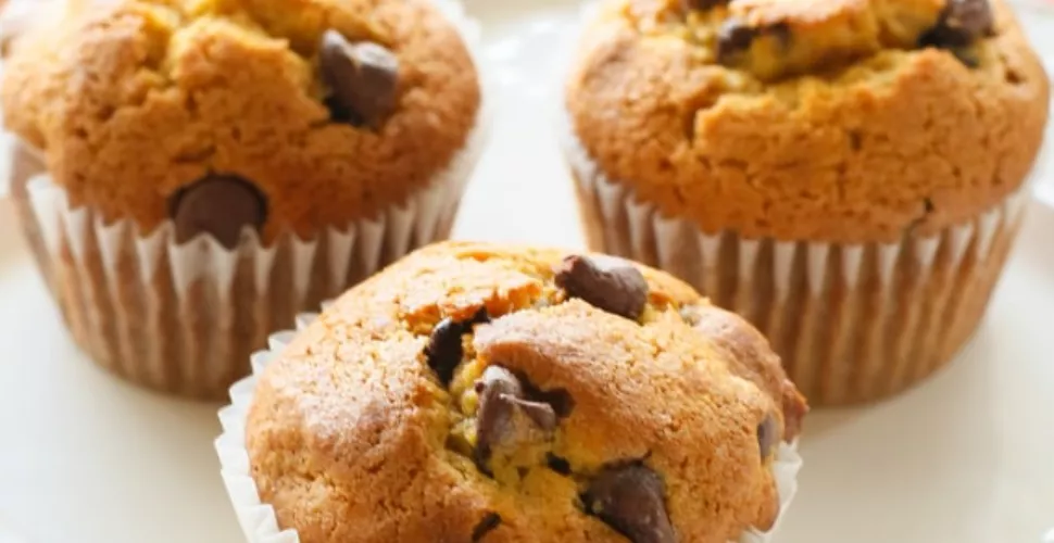 A plate of three pumpkin chocolate chip muffins.