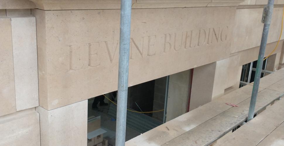 A section of the stonework in the Levine Building, with the words "Levine Building" carved into the stone.