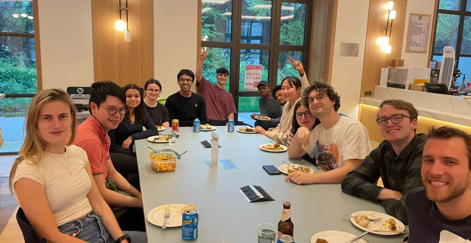 MCR students sit around a table in the Levine Cafe during a cultural potluck event.